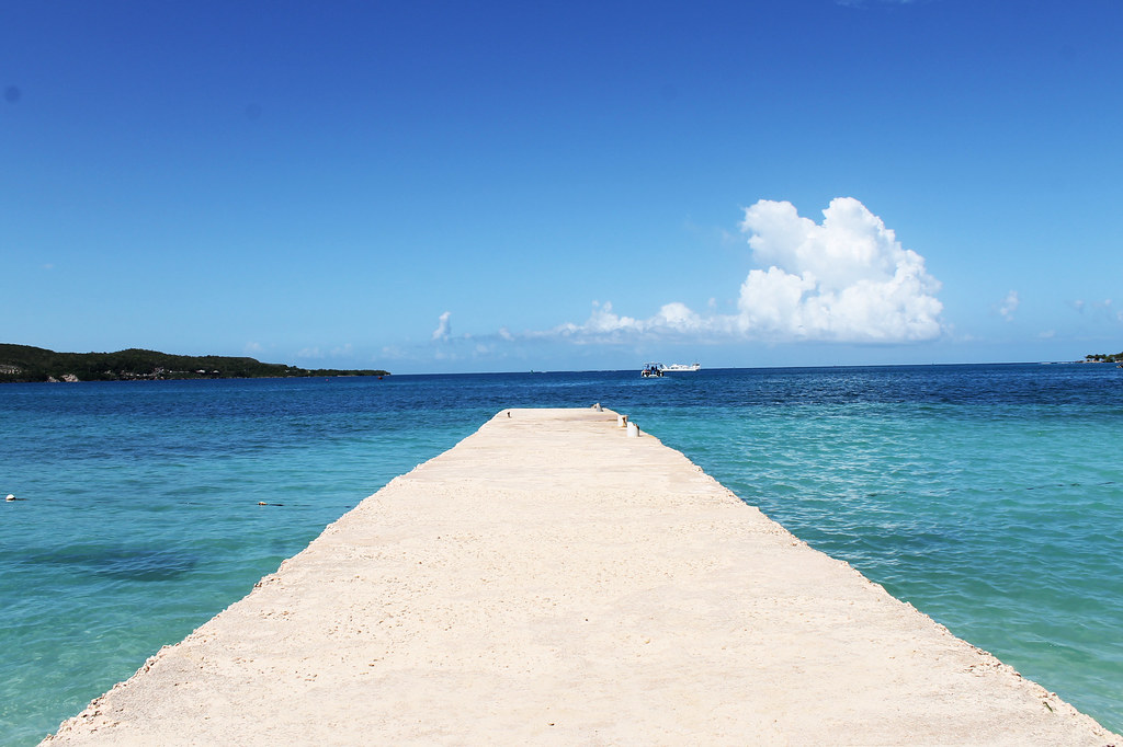 Puerto Seco Beach Club in Falmouth, Jamaica with white sandy beach, lounge chairs, and turquoise Caribbean waters.
