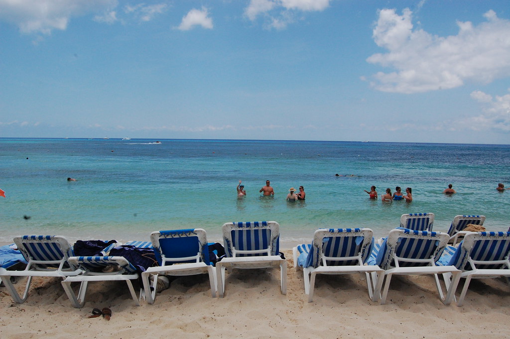 Mr. Sancho’s Beach Club in Cozumel, Mexico with white sand beach, palm trees, lounge chairs, and turquoise Caribbean water.