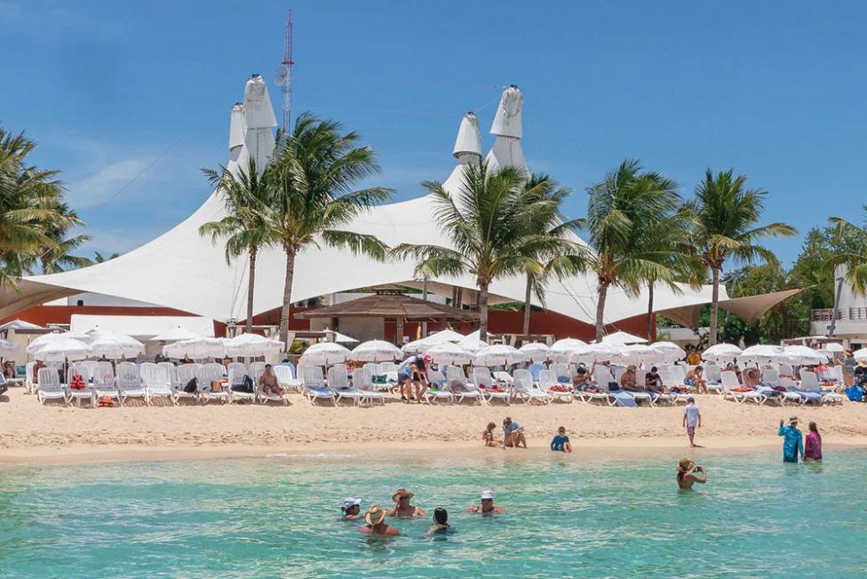 Playa Mia Grand Beach Park in Cozumel, Mexico with white sand beach, lounge chairs, pools, and Caribbean shoreline.